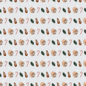 Gingerbread snowmen and houses with leaves and candy canes besides them