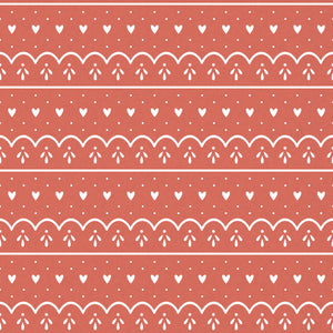 Red wrapping paper with white hearts, dots and scallops