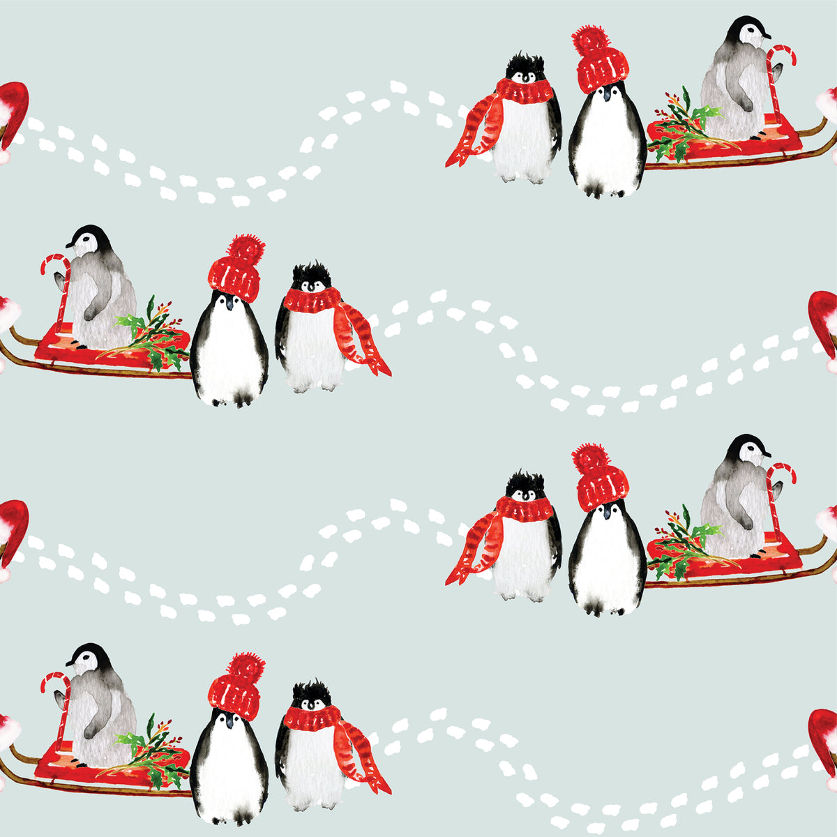 Penguins in a sled with red hats and scarfs