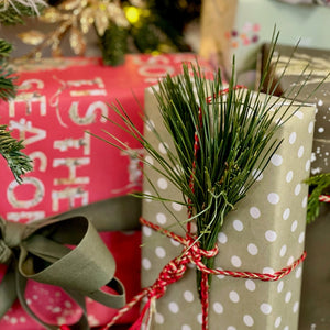 Christmas presents wrapped with green and red wrapping paper and decorated with red and green bows