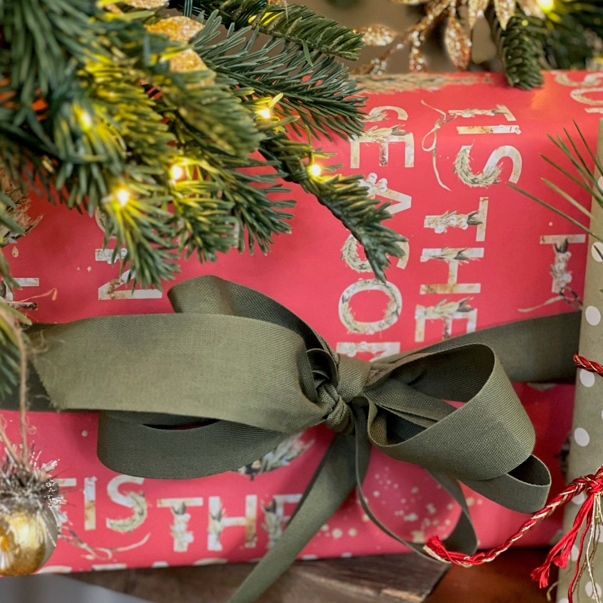 Christmas present wrapped in red gift wrap and a green bow