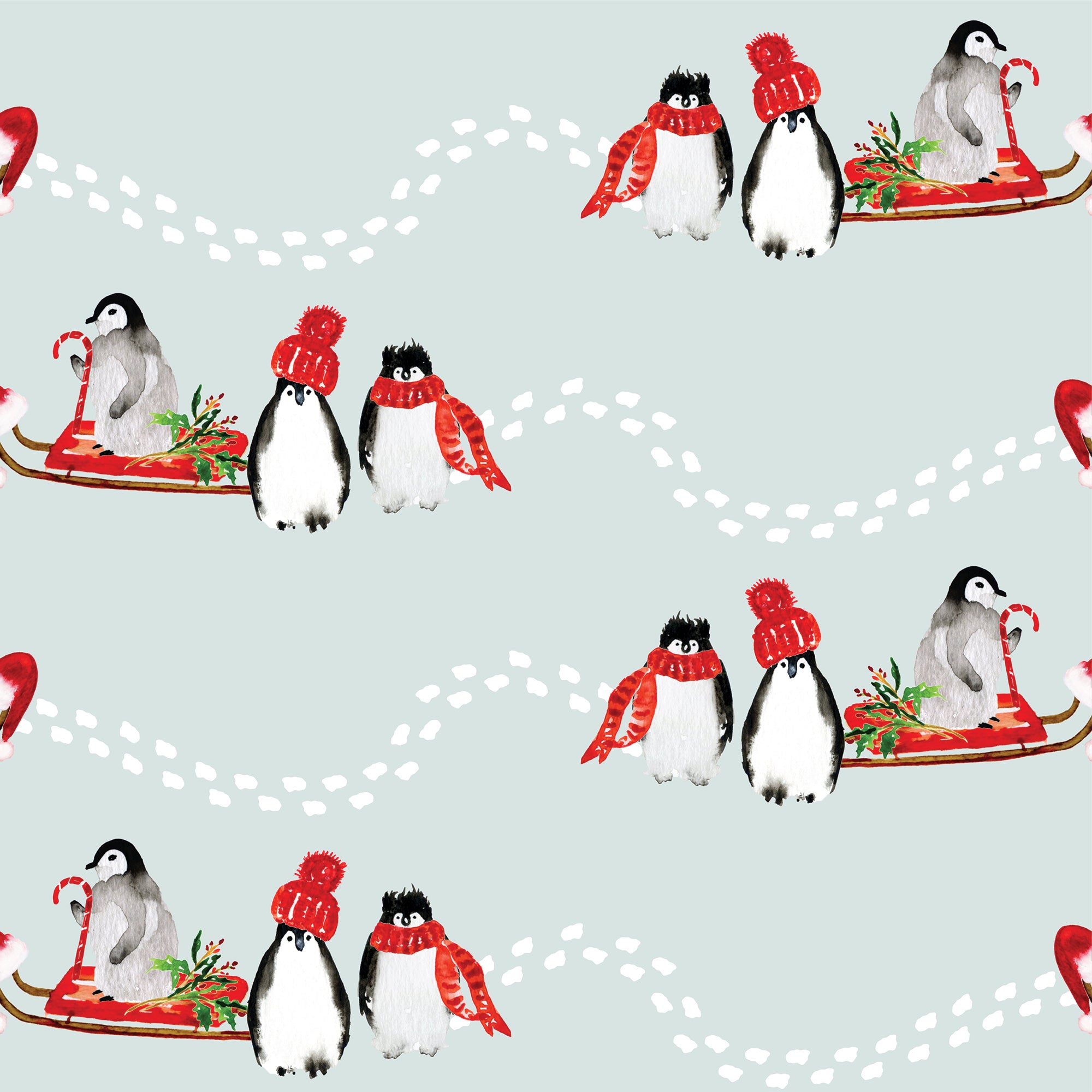 Penguins in a sled with red hats and scarfs